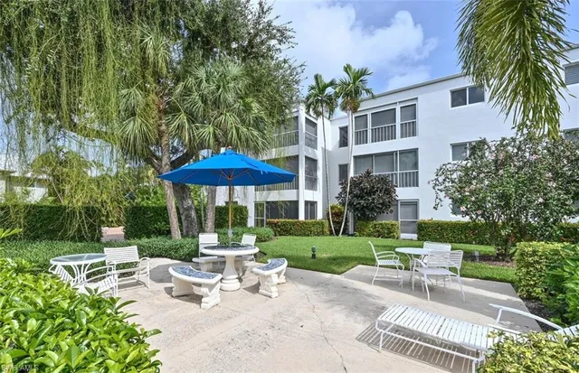 a view of a swimming pool with a garden and patio