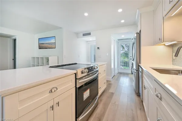 a kitchen with a stove and a sink