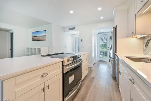 a kitchen with a stove and a sink