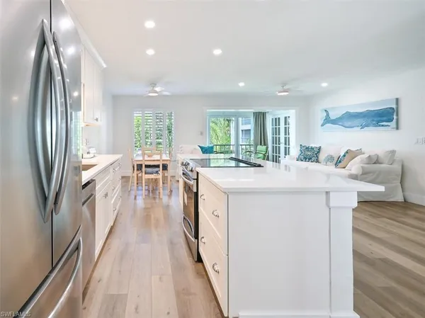 a kitchen with counter top space a sink appliances and cabinets