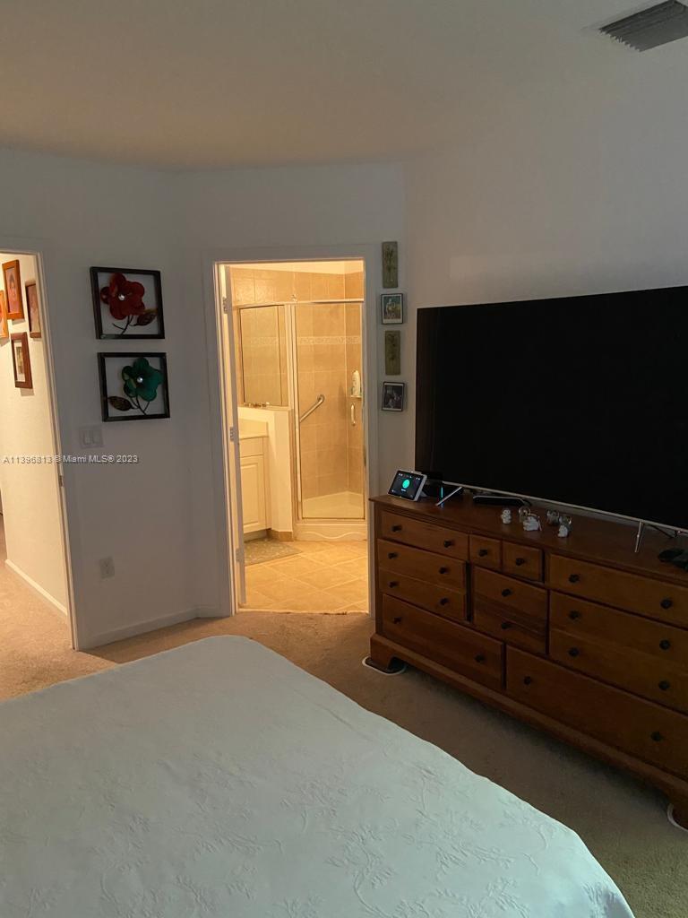 7765 Paddock Place, Unit 7765 Davie, FL 33328 - Photo 18 of 40 a room with furniture and flat screen tv