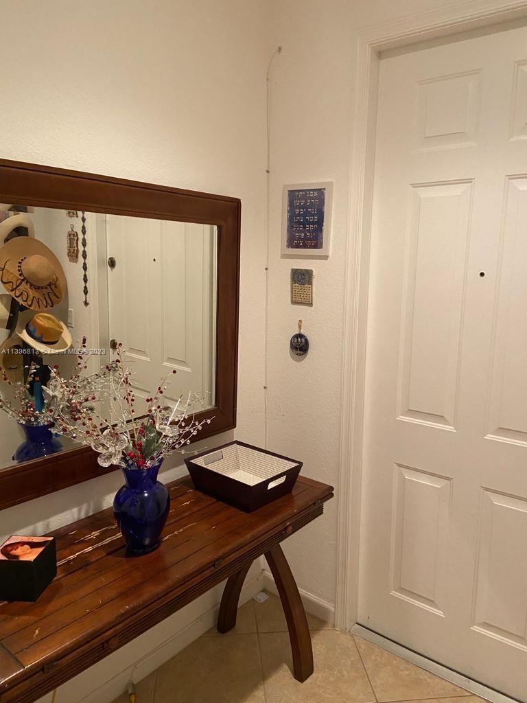 7765 Paddock Place, Unit 7765 Davie, FL 33328 - Photo 21 of 40 a room with a table and a potted plant