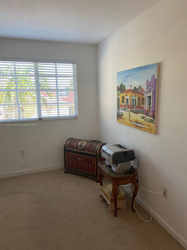 7765 Paddock Place, Unit 7765 Davie, FL 33328 - Photo 23 of 40 a living room with furniture and a window
