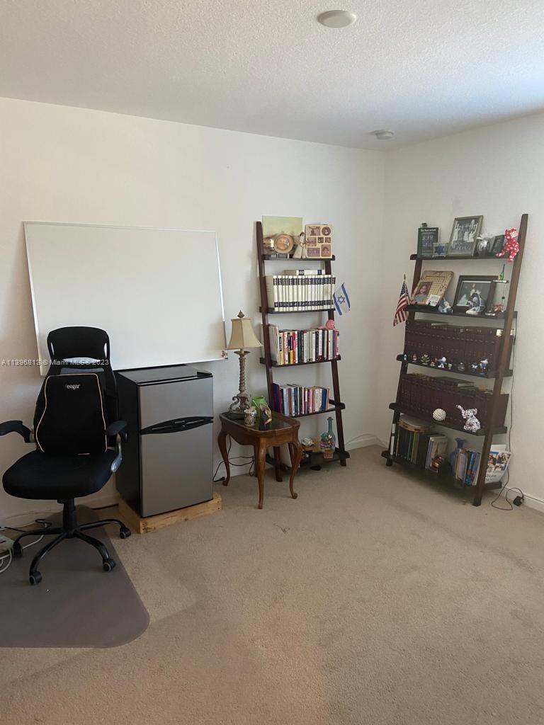 7765 Paddock Place, Unit 7765 Davie, FL 33328 - Photo 24 of 40 a bedroom with bed and a couch