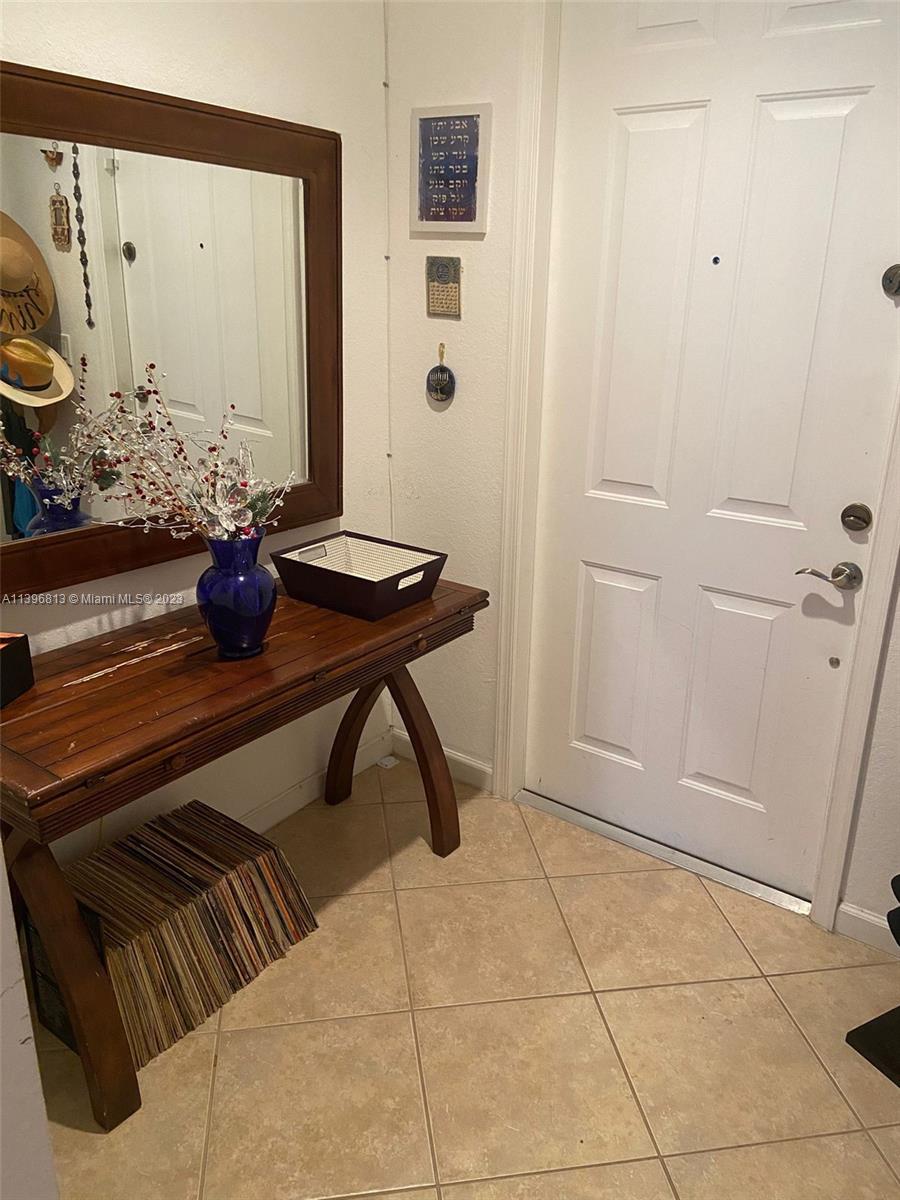 7765 Paddock Place, Unit 7765 Davie, FL 33328 - Photo 3 of 40 a bathroom with a sink and a mirror
