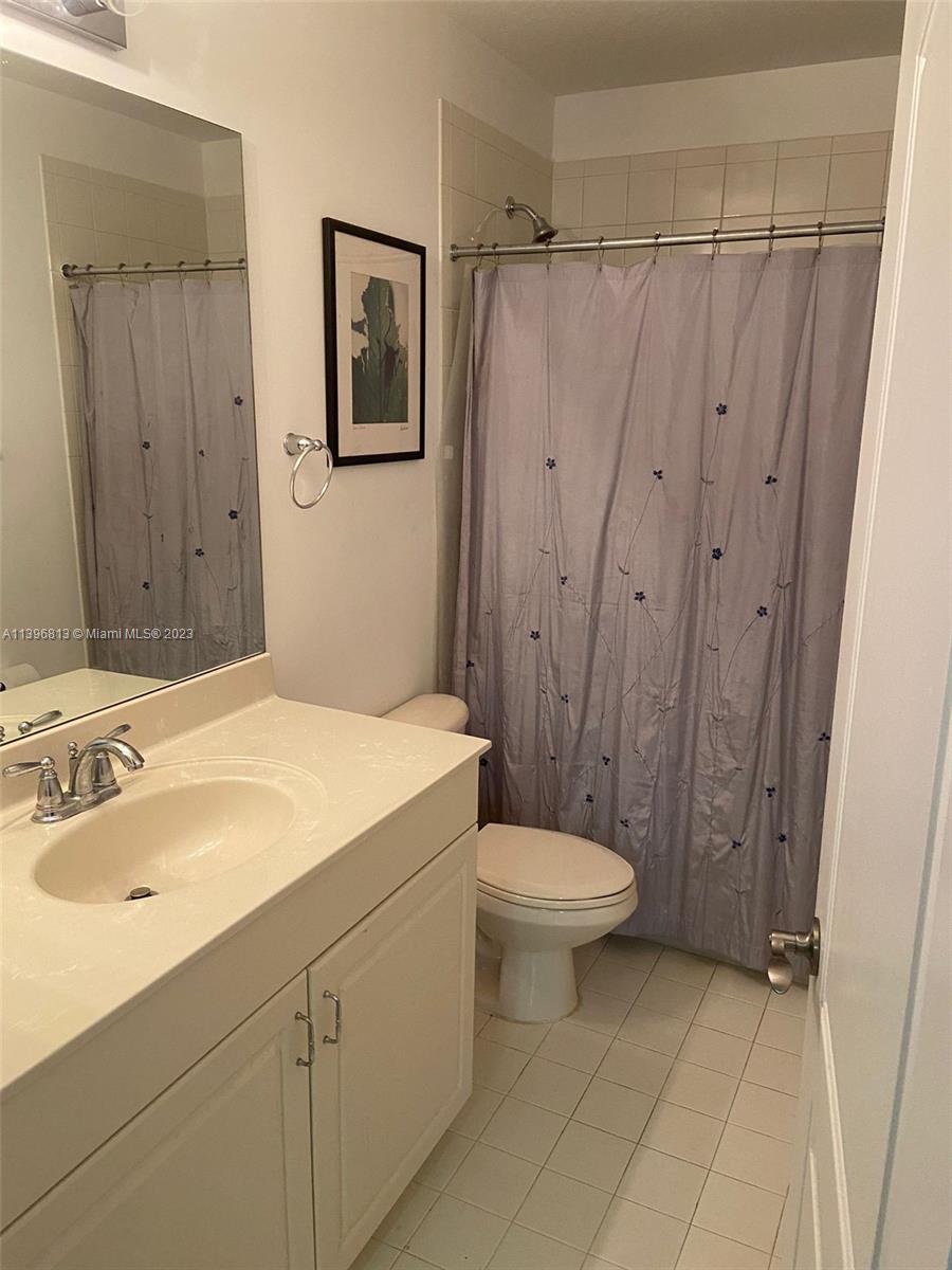 7765 Paddock Place, Unit 7765 Davie, FL 33328 - Photo 33 of 40 a bathroom with a sink a toilet and shower
