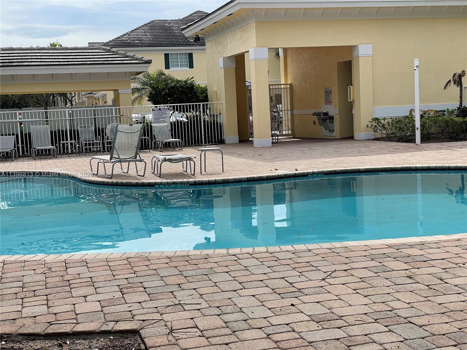 7765 Paddock Place, Unit 7765 Davie, FL 33328 - Photo 35 of 40 a front view of a house with a yard