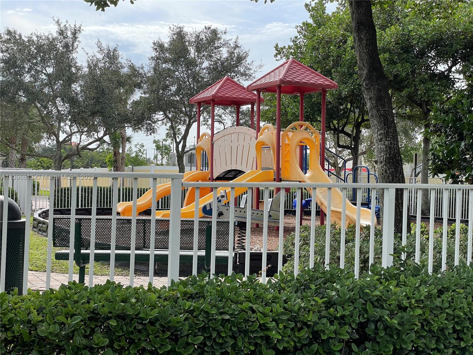 7765 Paddock Place, Unit 7765 Davie, FL 33328 - Photo 38 of 40 a view of a multi story residential apartment building with a yard and potted plants