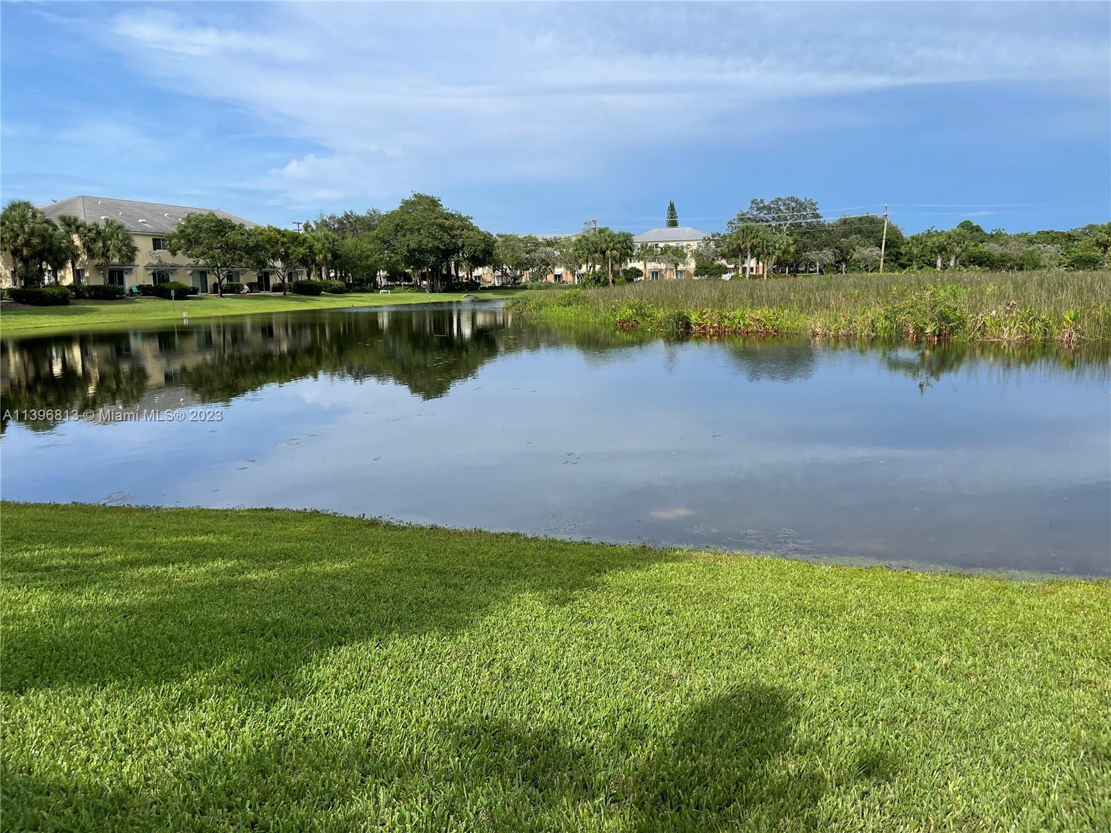 7765 Paddock Place, Unit 7765 Davie, FL 33328 - Photo 39 of 40 a view of a lake with houses in the back