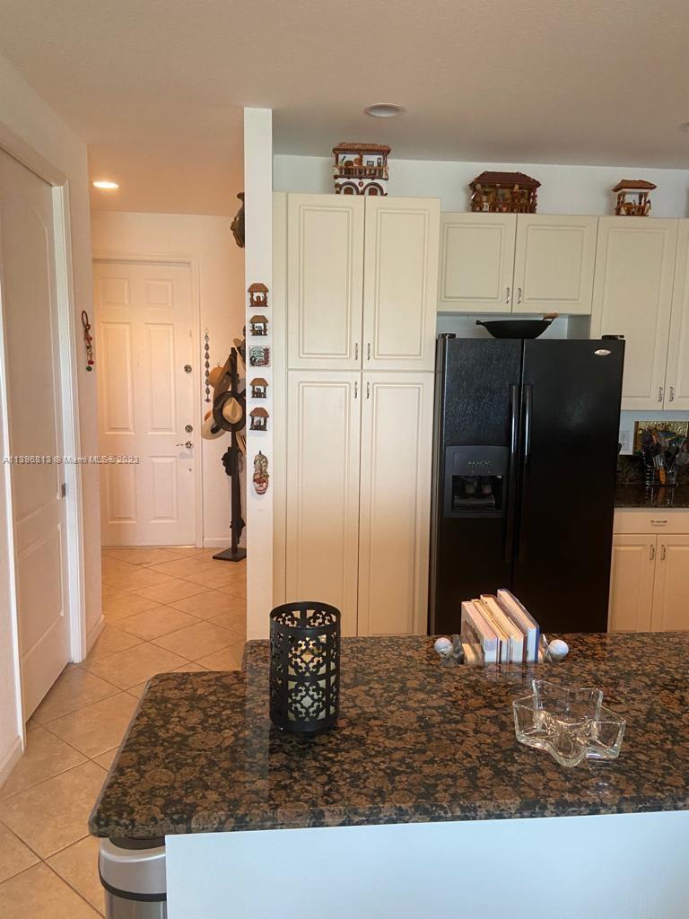 7765 Paddock Place, Unit 7765 Davie, FL 33328 - Photo 6 of 40 a kitchen with a refrigerator and a stove