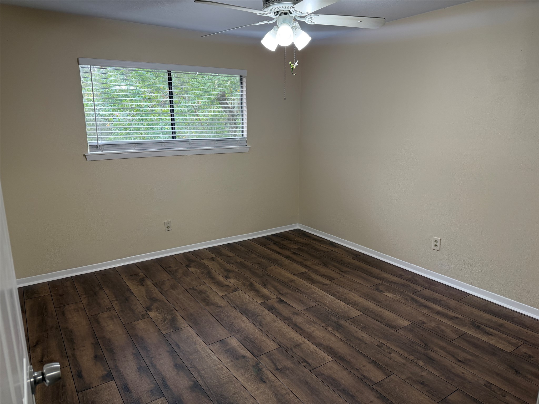 9 Dewthread Court Spring, TX 77380 - Photo 14 of 24 a view of an empty room with wooden floor and a window