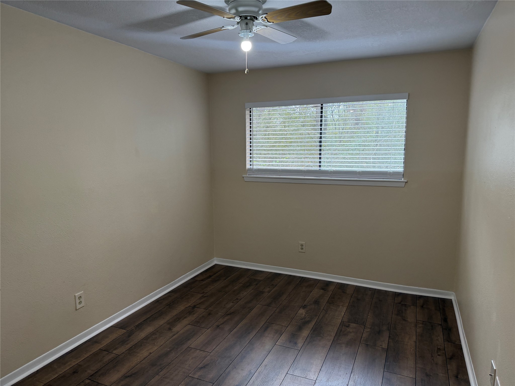 9 Dewthread Court Spring, TX 77380 - Photo 15 of 24 an empty room with wooden floor and windows