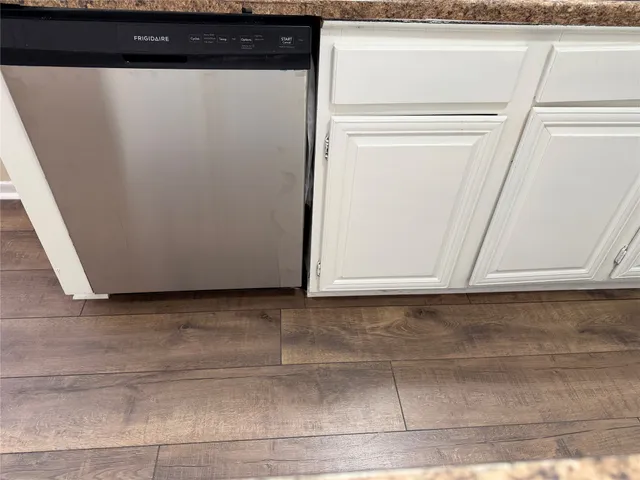 a view of a refrigerator with wooden floor