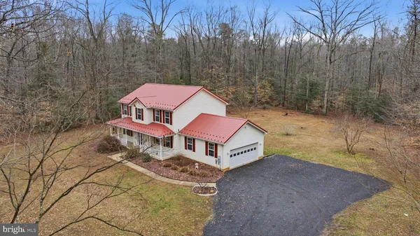 a aerial view of a house with a yard and balcony