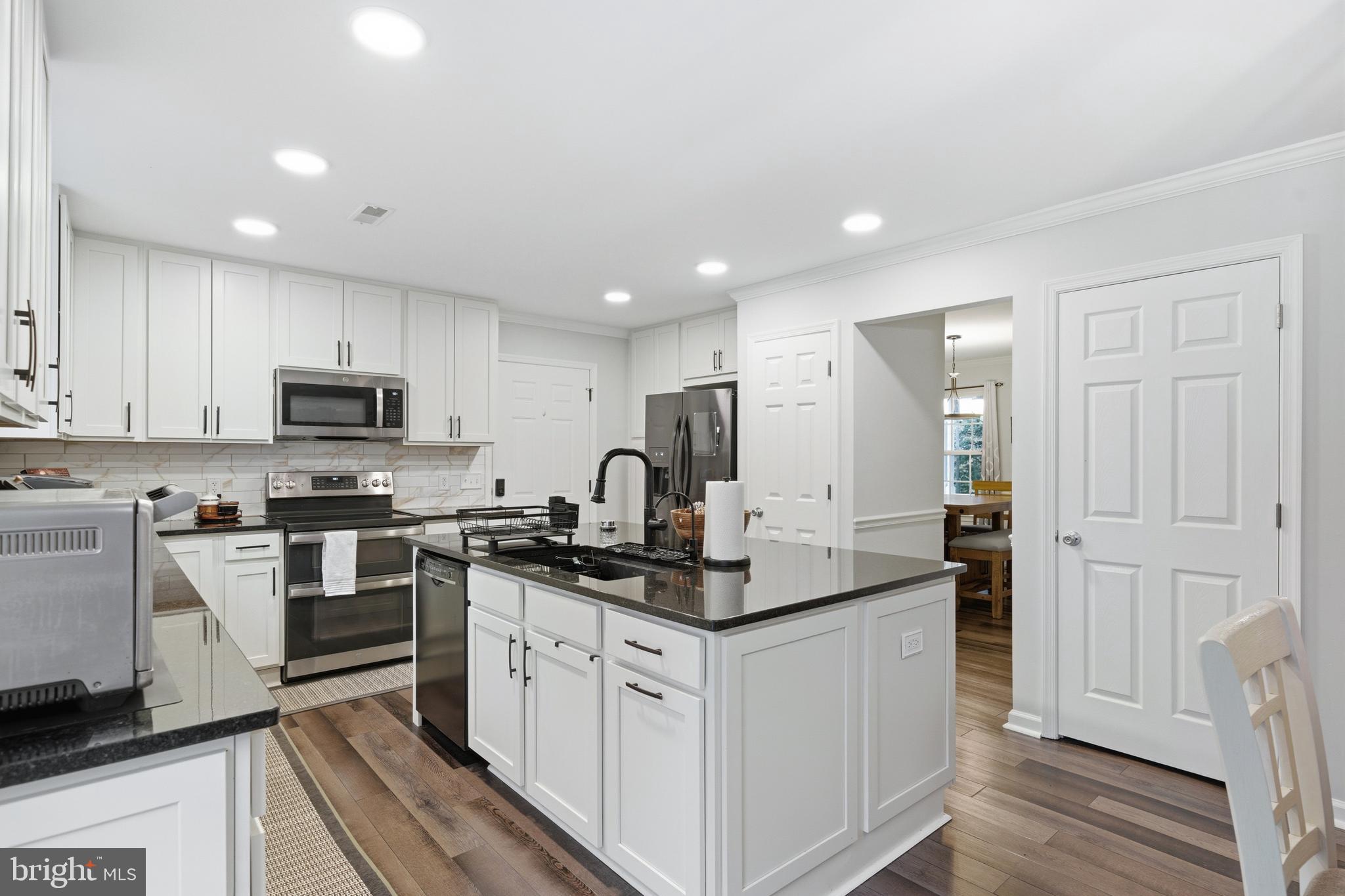 2550 Port Tobacco Road Nanjemoy, MD 20662 - Photo 20 of 70 a kitchen with stainless steel appliances granite countertop a stove a sink and a refrigerator
