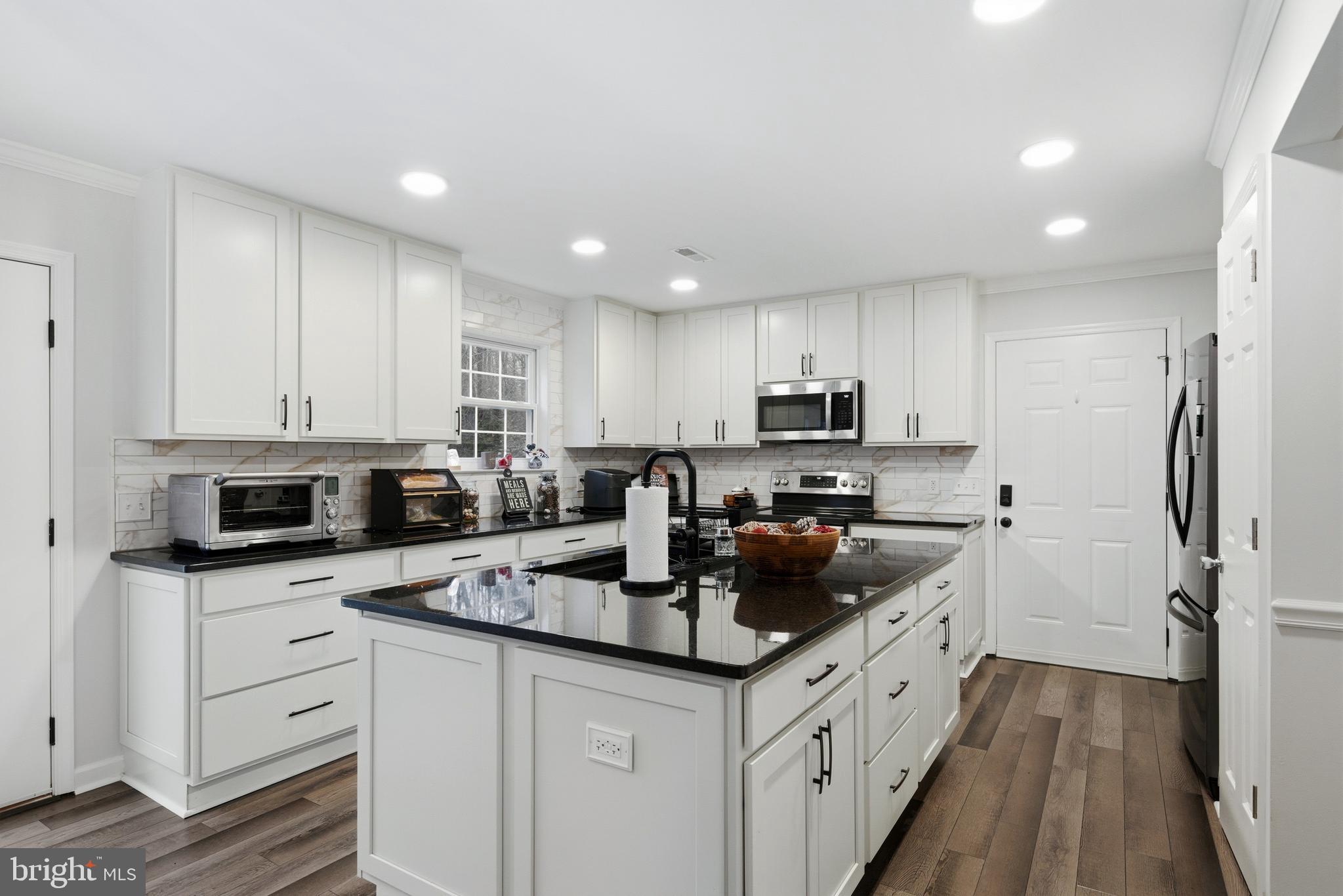 2550 Port Tobacco Road Nanjemoy, MD 20662 - Photo 21 of 70 a kitchen with granite countertop a sink stove and refrigerator