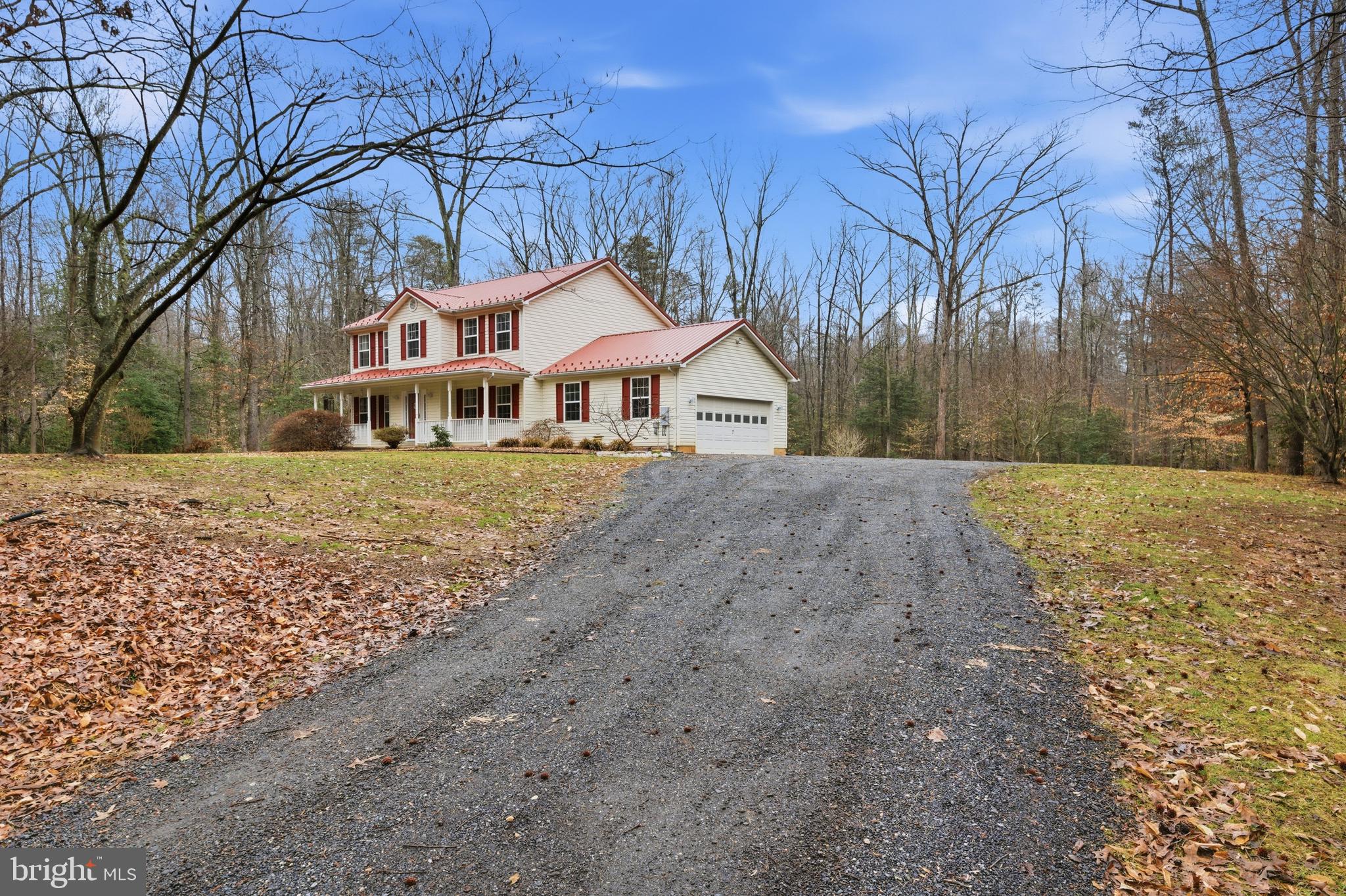 2550 Port Tobacco Road Nanjemoy, MD 20662 - Photo 22 of 70 a front view of a house with a yard covered with snow and trees
