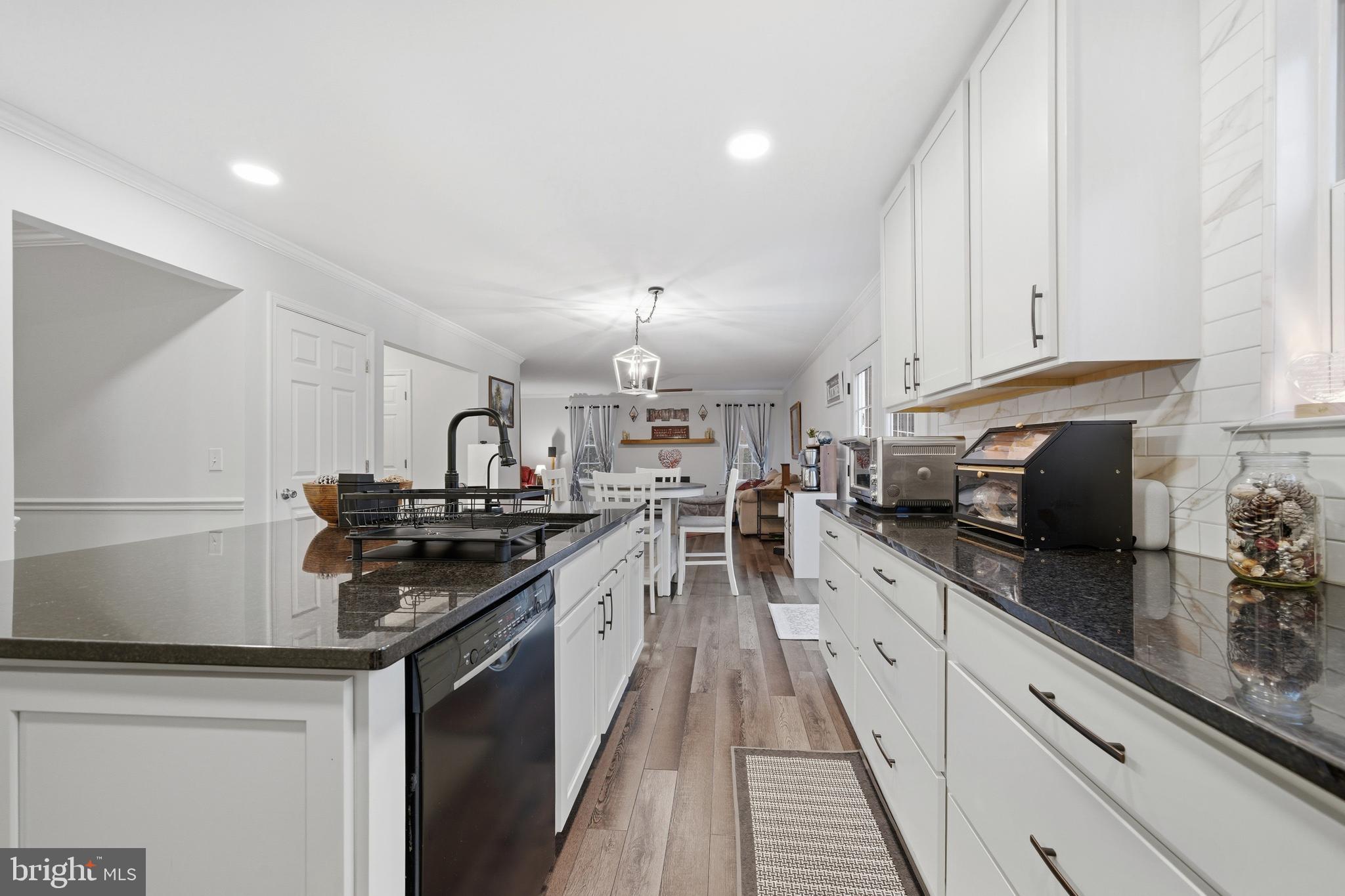 2550 Port Tobacco Road Nanjemoy, MD 20662 - Photo 26 of 70 a kitchen with granite countertop a sink stove and cabinets