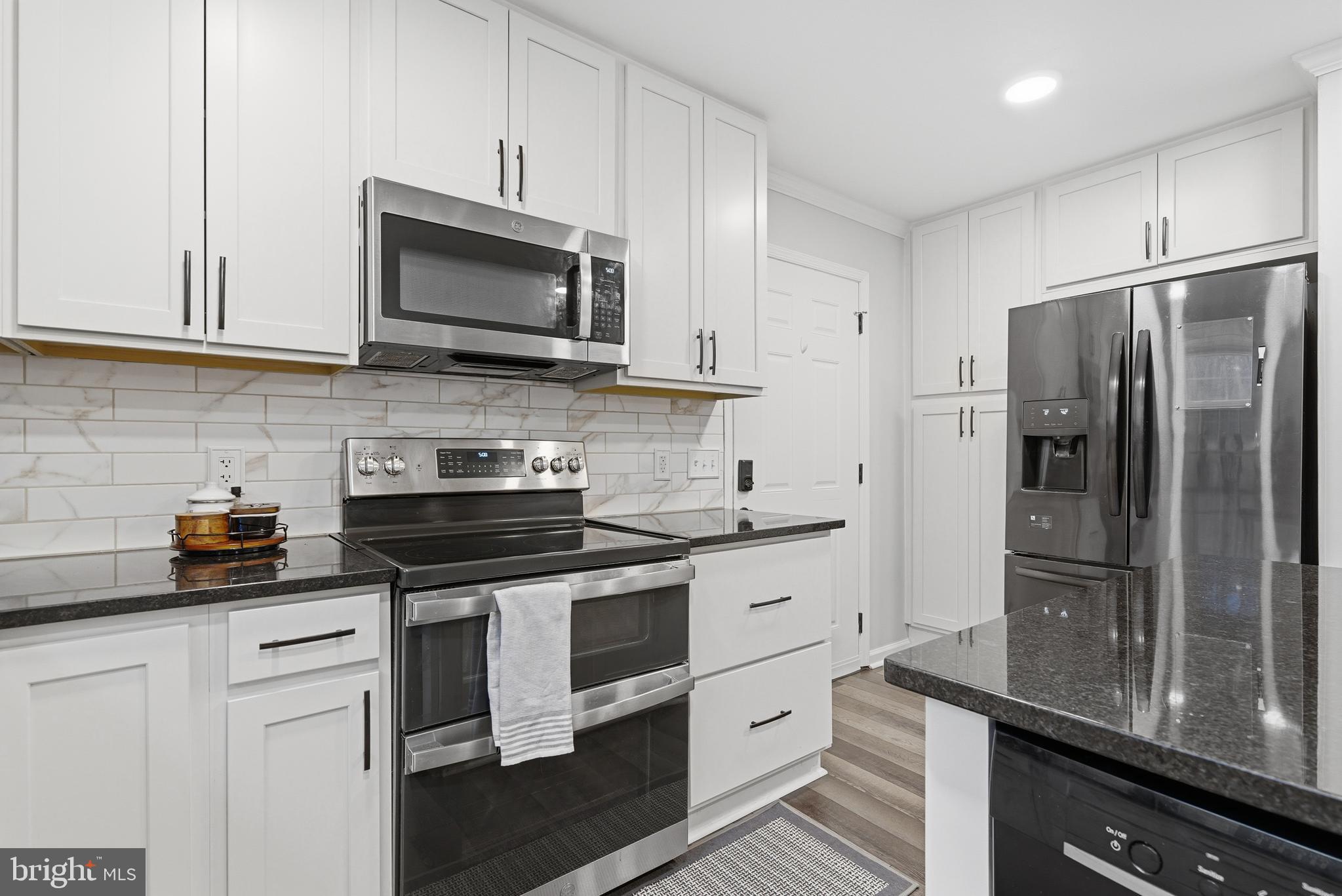 2550 Port Tobacco Road Nanjemoy, MD 20662 - Photo 27 of 70 a kitchen with stainless steel appliances a stove a sink a refrigerator and cabinets