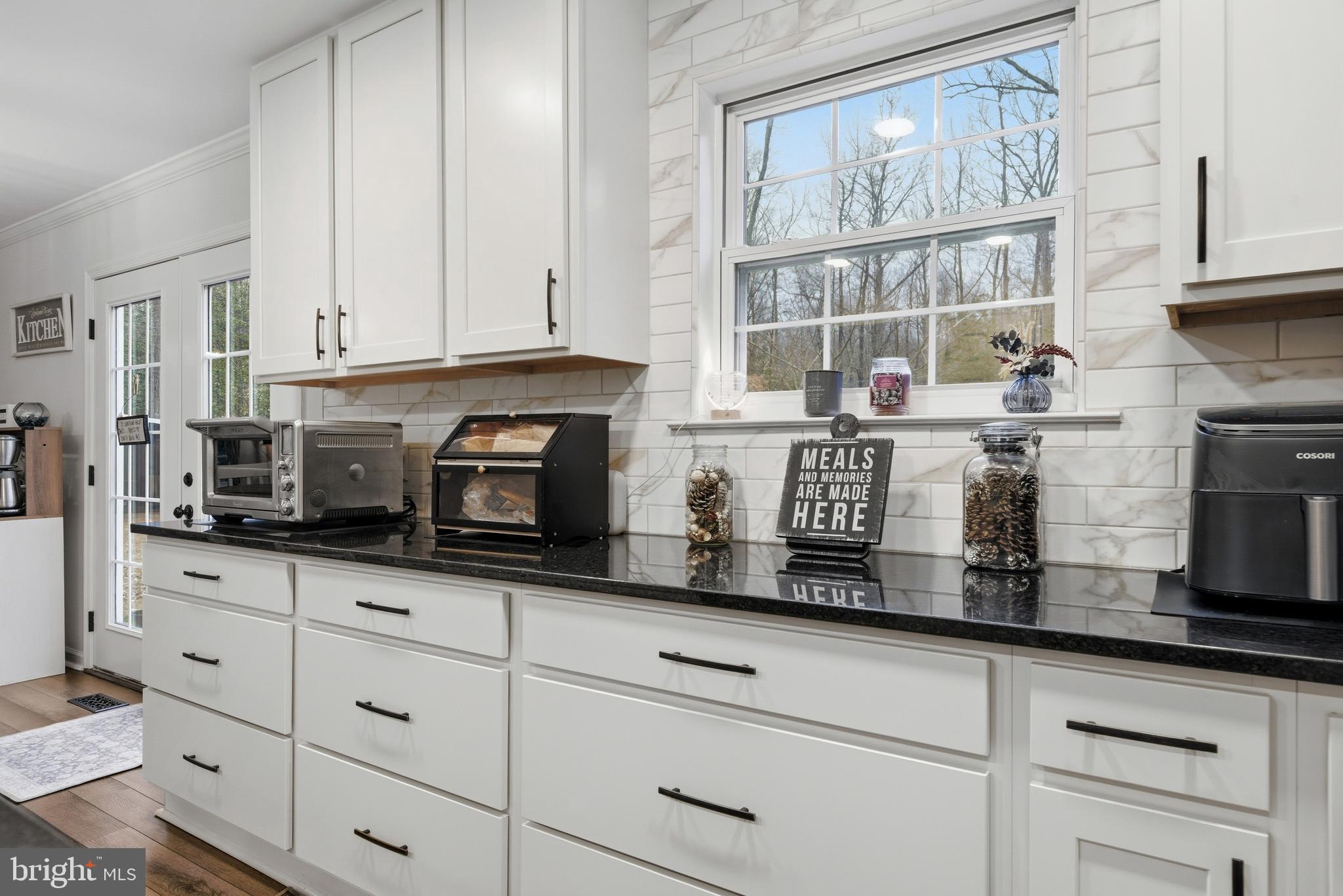 2550 Port Tobacco Road Nanjemoy, MD 20662 - Photo 29 of 70 a kitchen with granite countertop white cabinets and white stainless steel appliances