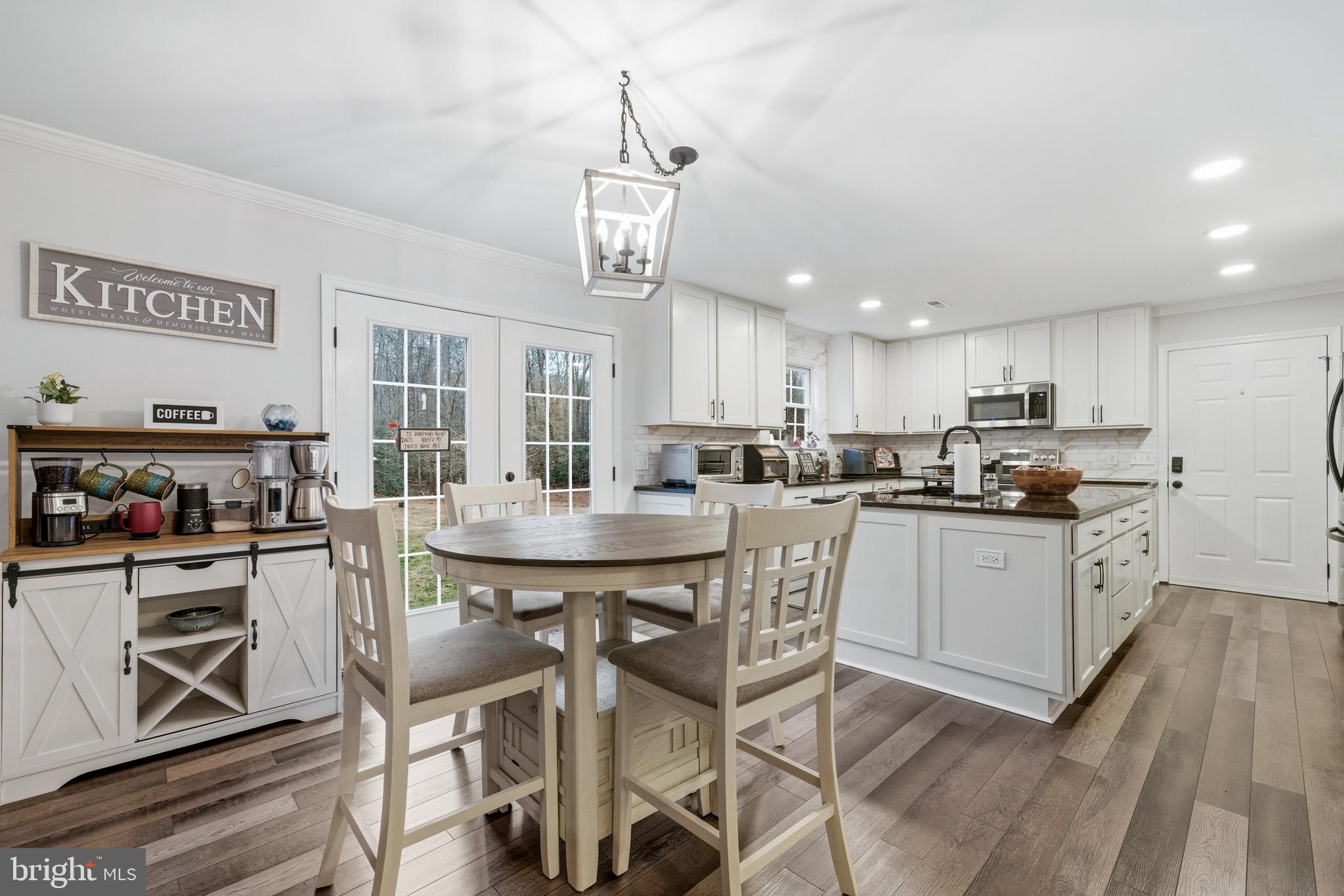 2550 Port Tobacco Road Nanjemoy, MD 20662 - Photo 6 of 70 a kitchen with stainless steel appliances kitchen island granite countertop a table chairs and a refrigerator