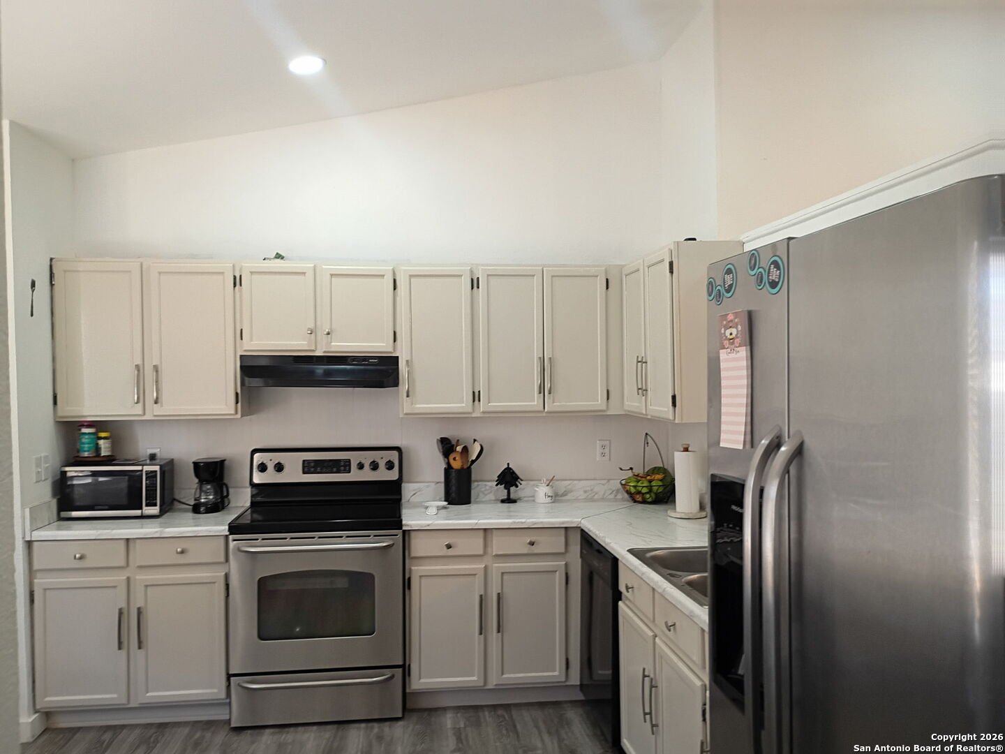 6723 Raintree Path San Antonio, TX 78233 - Photo 2 of 11 a kitchen with cabinets stainless steel appliances and a counter top space