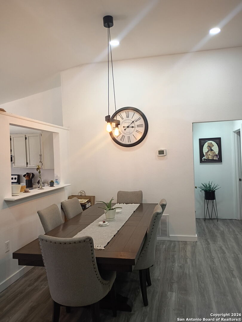 6723 Raintree Path San Antonio, TX 78233 - Photo 10 of 11 a view of a dining room with furniture wooden floor and chandelier