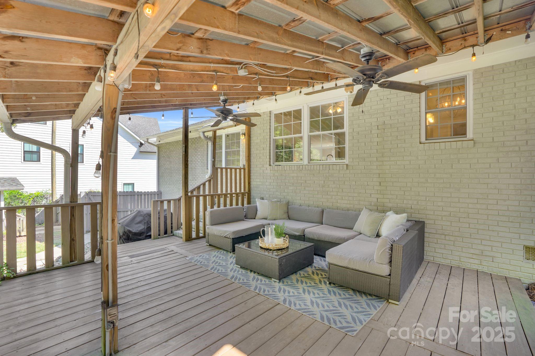 539 Hollis Road Charlotte, NC 28209 - Photo 17 of 23 a view of a patio with couches and table and chairs with wooden floor