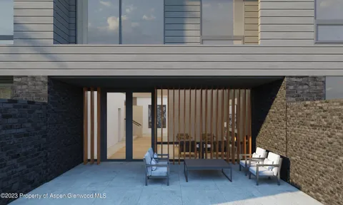 a living room with a balcony stairs and furniture