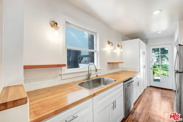 a kitchen with a sink and refrigerator