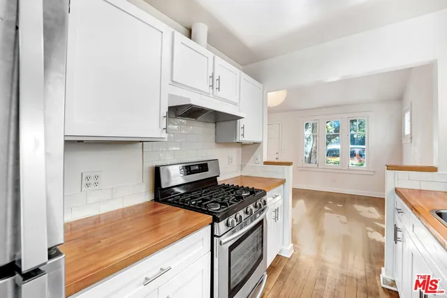 a kitchen with stainless steel appliances granite countertop a stove and a refrigerator