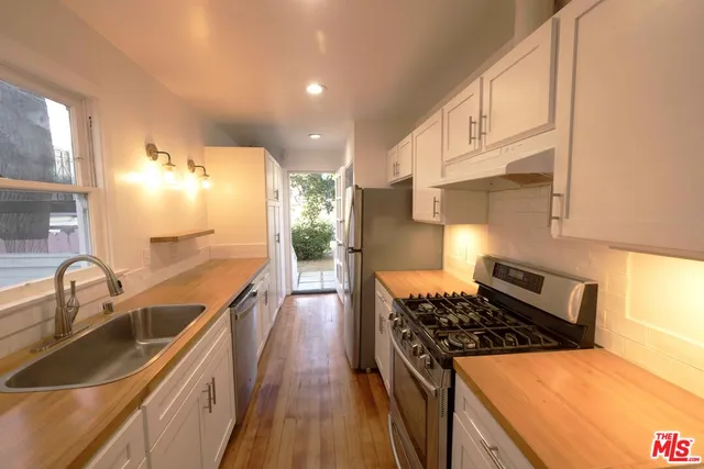 a kitchen that has a sink and a stove