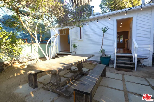 a view of backyard of house with seating space
