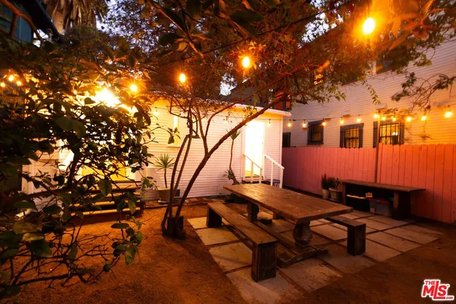 a backyard of a house with table and chairs