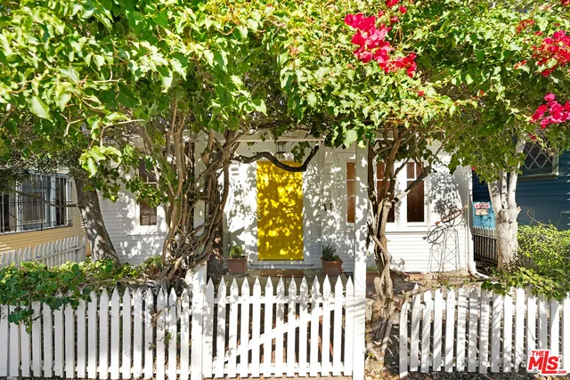 a view of a house with a flower garden