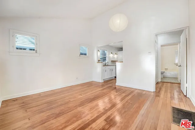 a view of empty room with wooden floor
