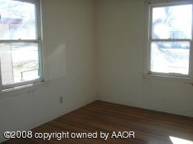 4115 South Hayden Street Amarillo, TX 79110 - Photo 3 of 6 a view of empty room with wooden floor and fan