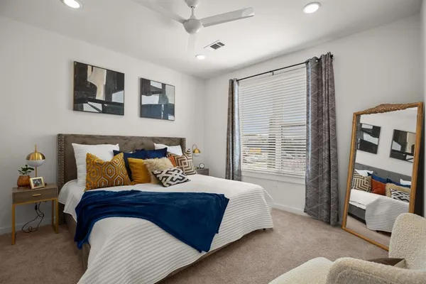 a bedroom with a bed and glass window