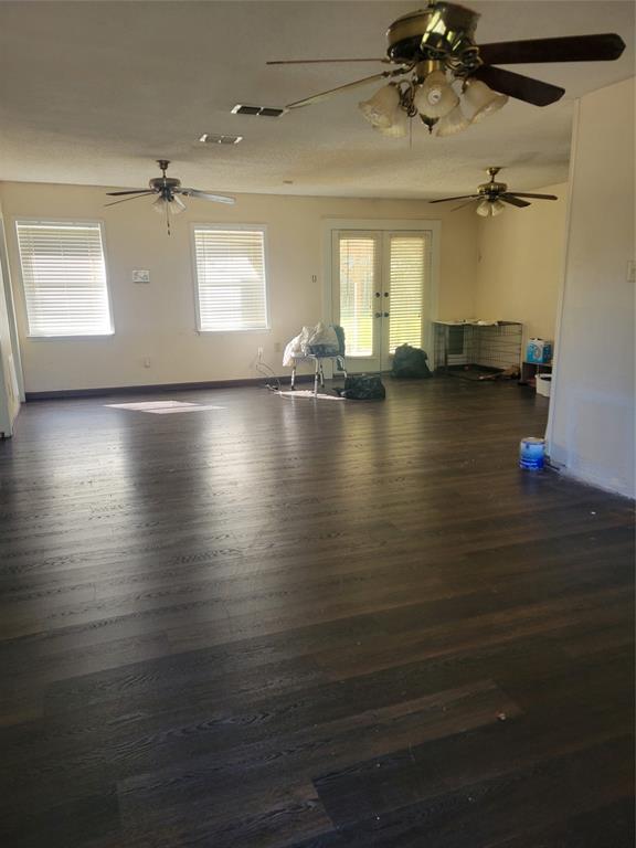 106 Allen Street Arp, TX 75750 - Photo 3 of 11 an empty room with wooden floor and windows