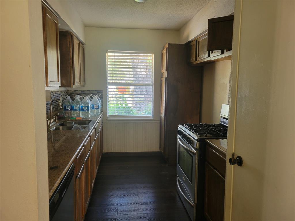 106 Allen Street Arp, TX 75750 - Photo 4 of 11 a kitchen with a stove and a refrigerator