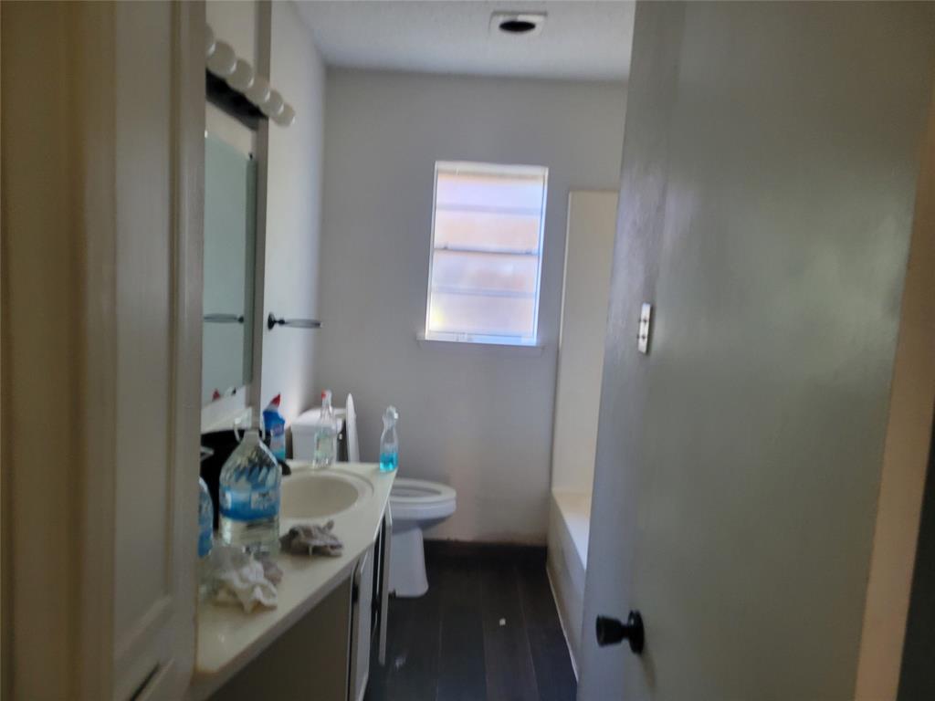 106 Allen Street Arp, TX 75750 - Photo 6 of 11 a bathroom with a granite countertop sink a toilet and a mirror