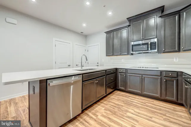 a kitchen with stainless steel appliances granite countertop a sink and stove top oven
