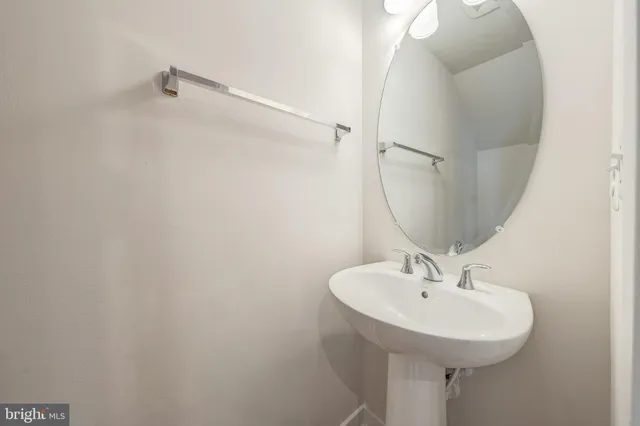 a bathroom with a sink a mirror and vanity