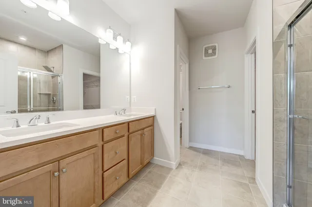 a spacious bathroom with a double vanity sink mirror and