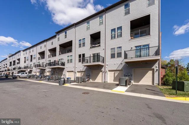 a view of a patio with a table and chairs under an umbrella with wooden floor