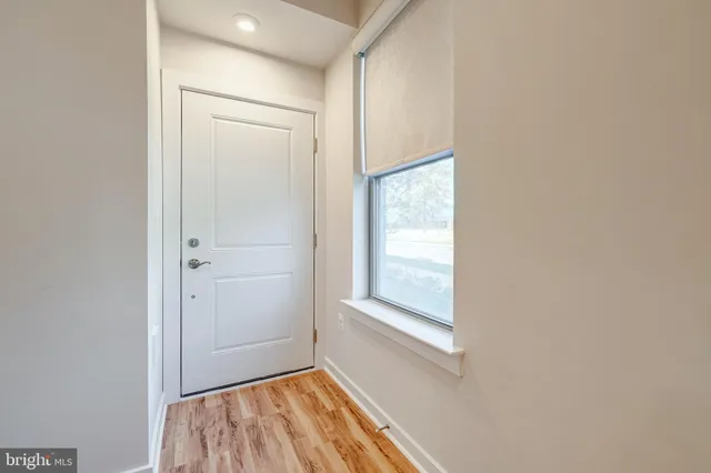 an empty room with windows and closet