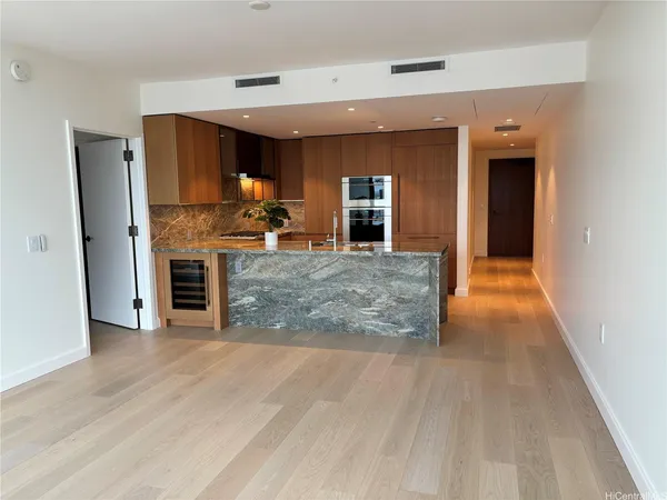 a view of kitchen with sink and refrigerator
