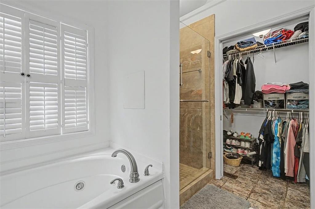 409 Windsor Way Canton, GA 30115 - Photo 18 of 51 a view of walk in closet with clothes and shoes