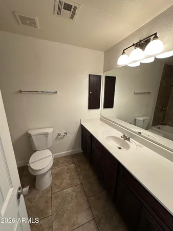 a bathroom with a sink toilet and mirror