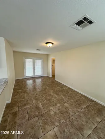 an empty room with a empty space and windows